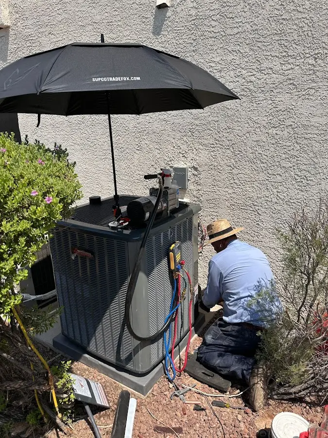 HVAC technician performing outdoor AC maintenance in Seymour
